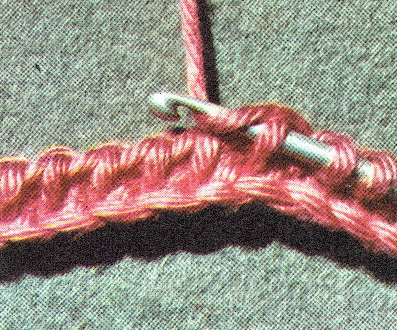 Working the third row, inserting the hook into the upright thread of the previous row.